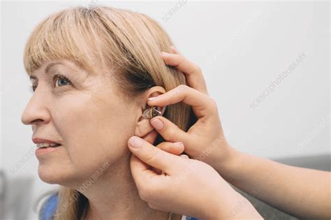 Hearing aid fitting - Stock Image - F036/3003 - Science Photo Library