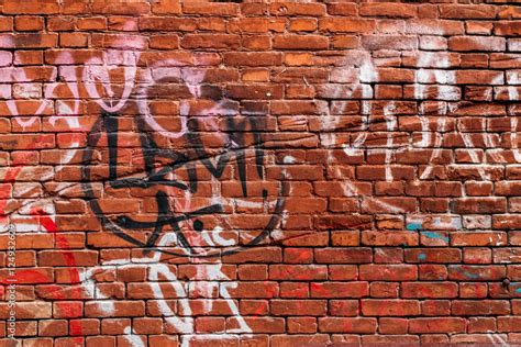 red brick wall with graffiti in different colors Stock Photo | Adobe Stock