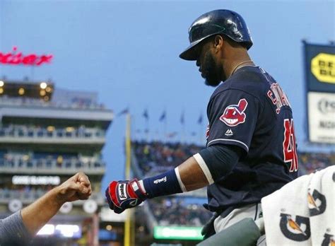 Cleveland Indians' Carlos Santana is greeted in the dugout after his ...