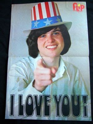 a woman in a patriotic hat pointing at the camera with an i love you ...