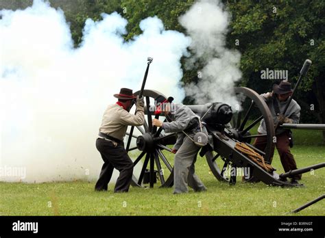 Confederate soldiers firing a cannon during a battle at a Civil War ...