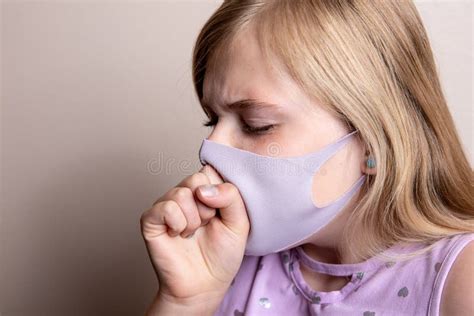 Sick Young Girl Coughing into Her Mask Stock Photo - Image of cough ...