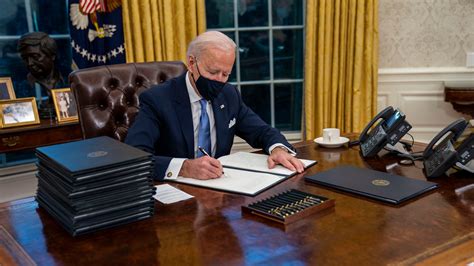 In the Oval Office for the first time as president, Biden begins to ...