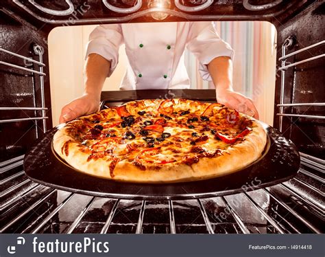 Chef Cooking Pizza In The Oven. Picture