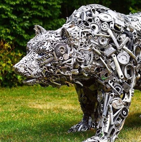 a bear made out of metal parts in the grass