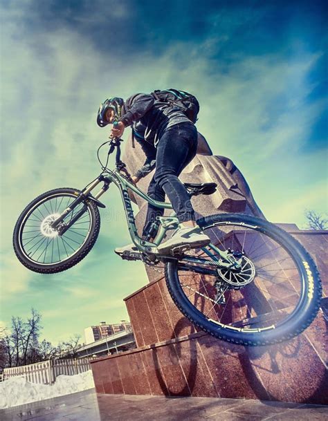 A Sports Cyclist Guy Doing Tricks on Bicycle in Urban Area. City ...