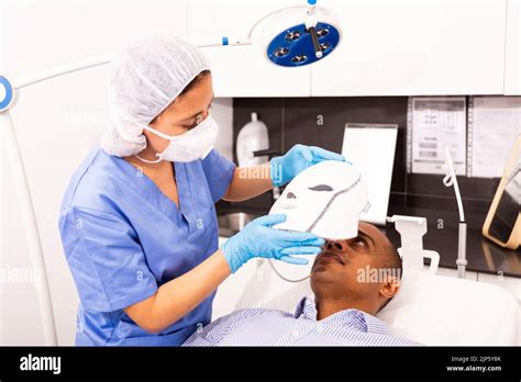 Male client getting face phototherapy procedure in clinic Stock Photo ...