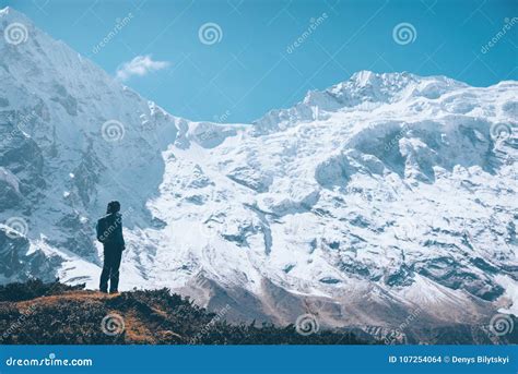 Woman on the Mountain Trail and Looking on Snow Covered Rocks Stock ...