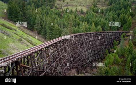 Antique wooden train track and bridge lead through an Idaho forest ...