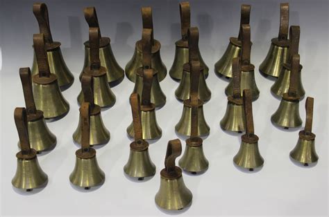 A set of twenty-five 20th century brass musical hand bells, ranging ...