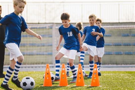 Soccer Boy on Training with Ball and Soccer Cones. Dribbling Drill ...