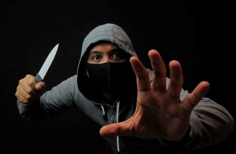 Premium Photo | Close up man holding knife in the dark