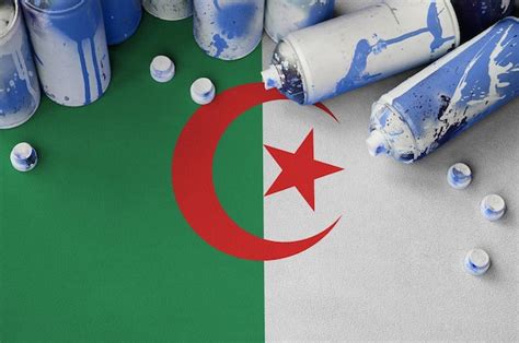 Premium Photo | Algeria flag and few used aerosol spray cans for ...