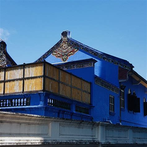 a large blue building with ornate designs on it's roof and sidewalls