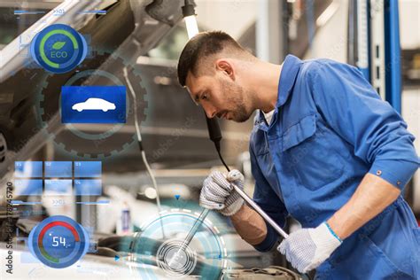 mechanic man with wrench repairing car at workshop Stock Photo | Adobe ...