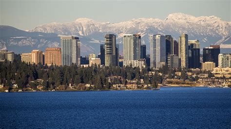 the city is surrounded by tall buildings and snow covered mountains in ...