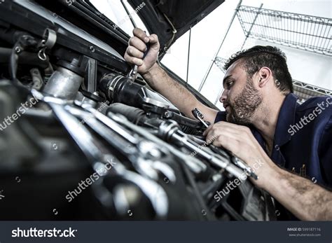 Car Mechanic Man Garage Fixing Engine Stock Photo 599187116 | Shutterstock