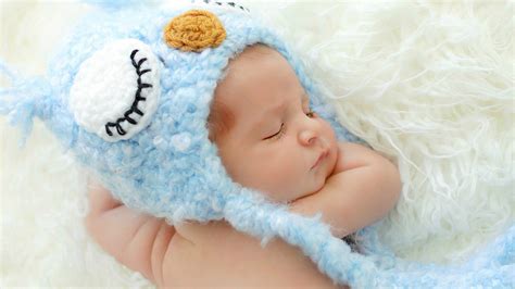 Cute Newborn Baby Is Sleeping On White Woolen Bed Wearing Knitted ...