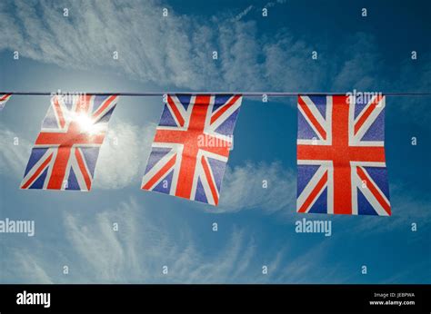 British flags bunting against blue sky Stock Photo - Alamy