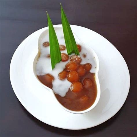 a white plate topped with beans and milk