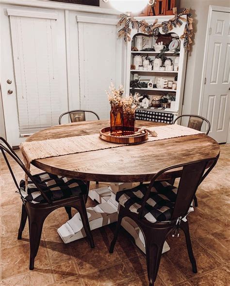 White Round Dining Table with Floral Centerpiece and Chandelier