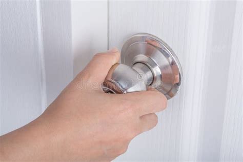 Hand Opening Door Knob on White Door Stock Image - Image of home, metal ...