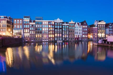 Damrak Canal at Night, Amsterdam, Netherlands Stock Photo - Image of ...