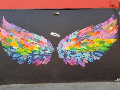 Wings on the wall. Artistic painting of colourful angel wings on a wall ...