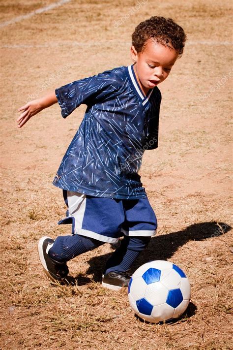 Young African American boy playing soccer — Stock Photo © RobHainer ...