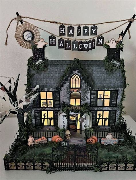 a house decorated for halloween with pumpkins and decorations