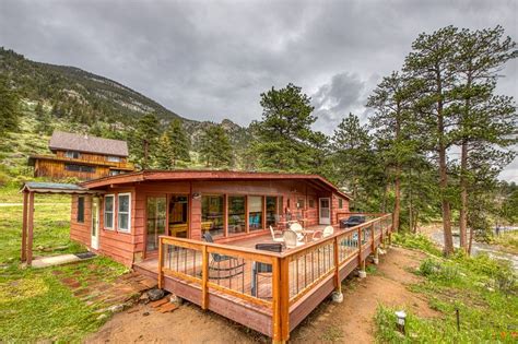 Cozy, waterfront river cabin with mountain views & private hot tub ...