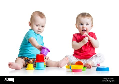 Cute babies playing with color toys. Children girl and boy sitting on ...