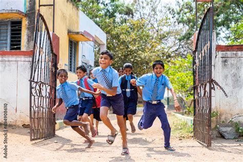 Children running out from school by opening gate after the bell ...