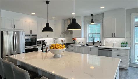 An Avid Baker Designs a Huge Island in His L-Shaped White Kitchen