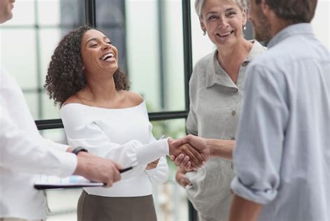 Premium Photo | Smiling multiethnic businesspeople shaking hand in office