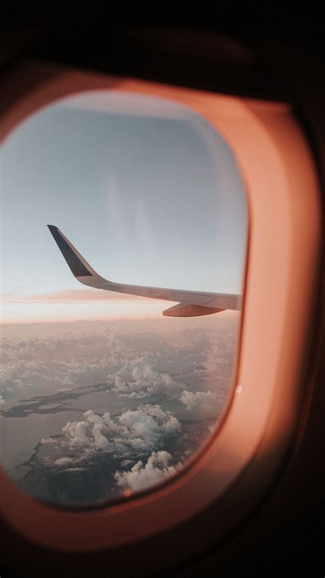 Download wallpaper 2160x3840 porthole, airplane window, aircraft wing ...