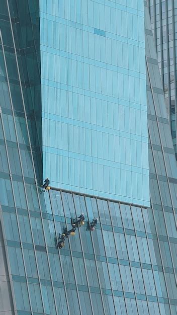 Premium Photo | Workers cleaning windows on a building