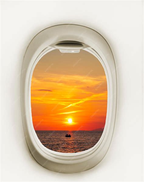 Premium Photo | Airplane window with red sun Airplane window Sunset and ...