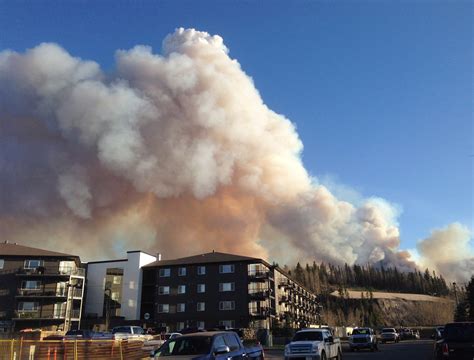 Smoke from a wildfire fills the sky in downtown Fort McMurray looking ...