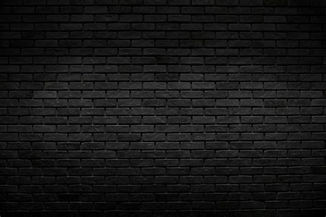 The old vintage black brick wall background with lighting decoration ...