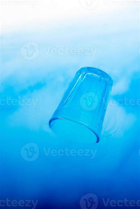 Blue color glass placed in blue water 14879915 Stock Photo at Vecteezy