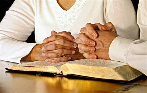 Couple Praying with Holy Bible — Stock Photo © lincoln@lincolnrogers ...