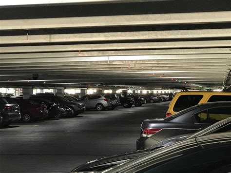 This mall parking lot has indicators above each spot to say if someone ...