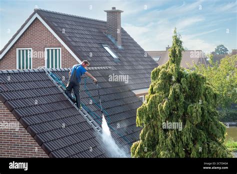 Pressure washing roof tiles hi-res stock photography and images - Alamy