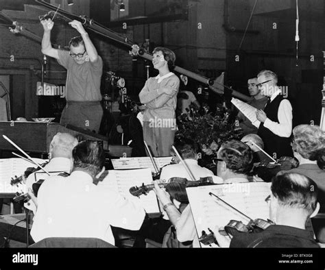 Julie Andrews singing with an orchestra in a recording studio for Stock ...