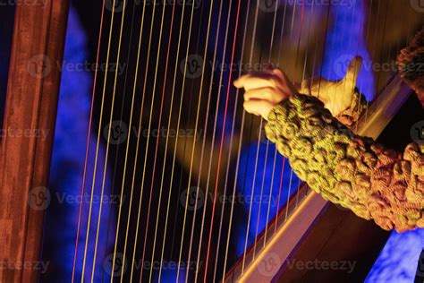 hands playing harp detail 20220959 Stock Photo at Vecteezy