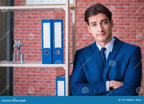 The Young Employee with Employee of the Month Trophy Stock Photo ...