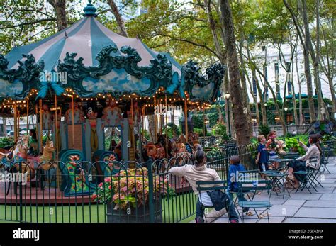 Children riding a carousel in the Winter Village at Bryant Park ...