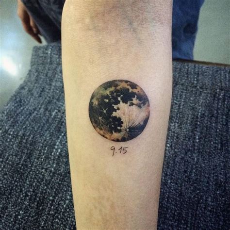 Realistic moon tattoo on the forearm.