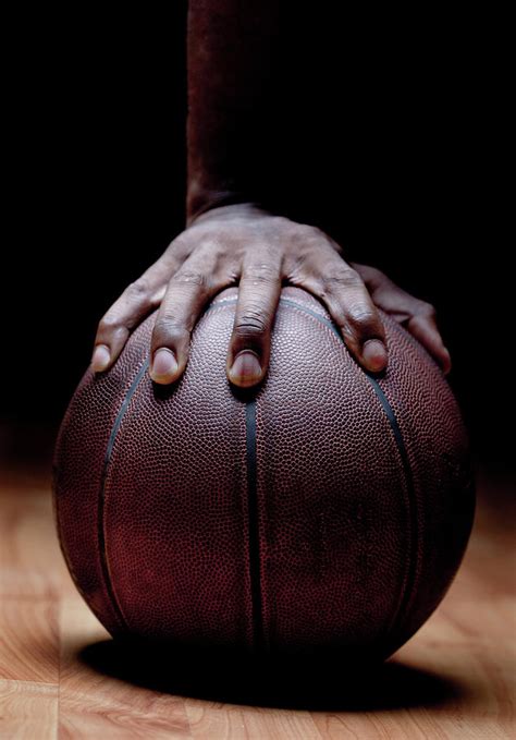 Mans Hand On Basketball Photograph by Pkline - Fine Art America